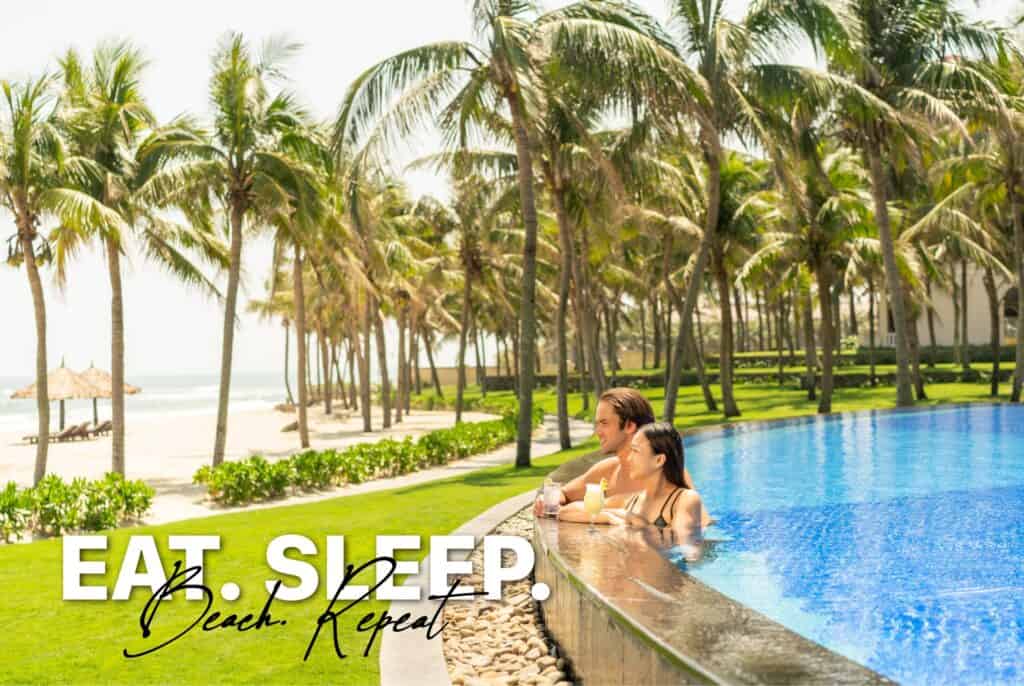 A couple enjoys a beachfront pool at a luxury resort in Vietnam