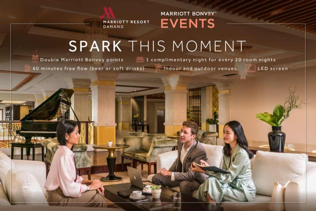 A group of business colleagues chat in the Great Room of a Marriott Hotel lobby.