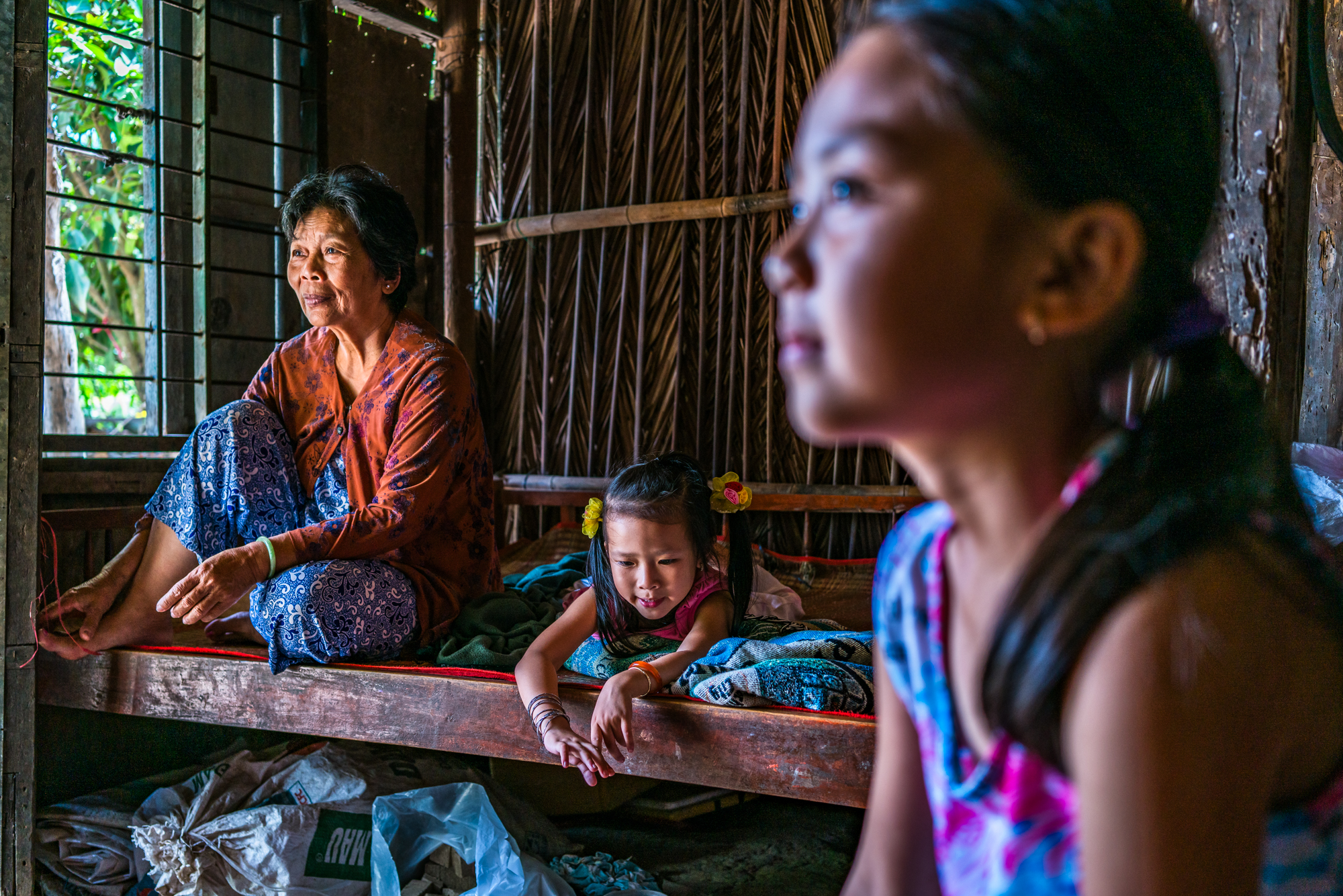 A grandmother and her grandchild in their rural home in the Mekong Delta region of Vietnam
