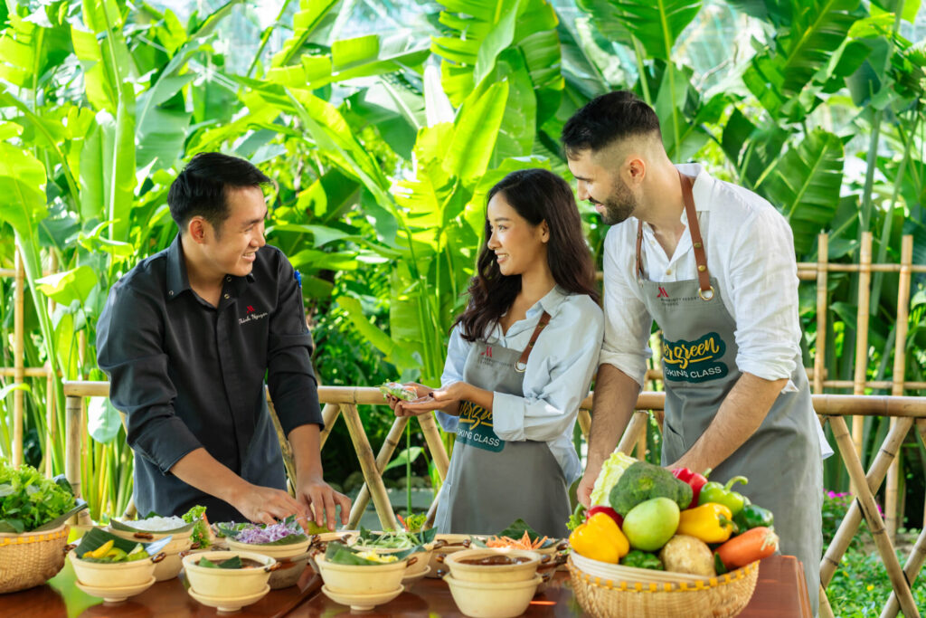 A couple enjoys a cooking class with the chef at Danang Marriott Resort & Spa in Vietnam.