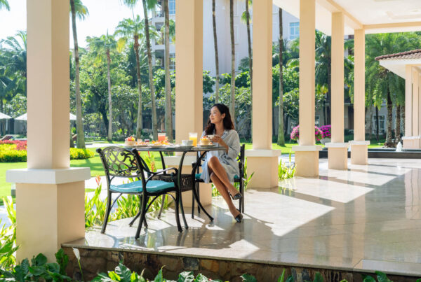 A woman enjoys a healthy breakfast at a beachfront resort in Vietnam.