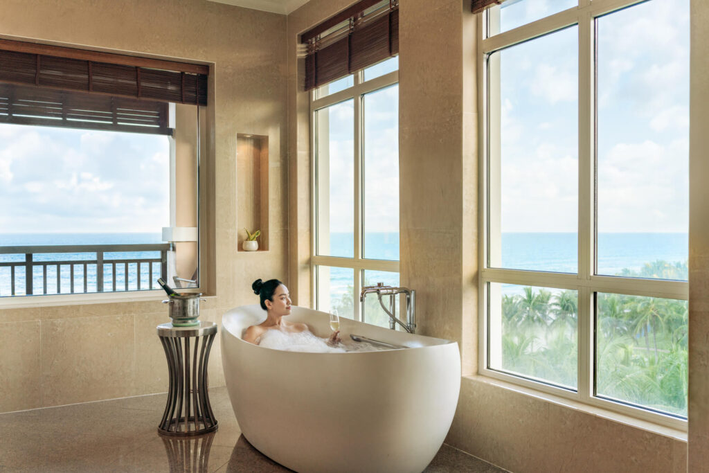 A woman enjoys a bath with a view at a luxury resort in Vietnam.