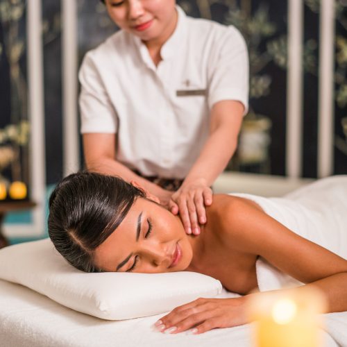 A woman gets a massage in a luxury hotel spa