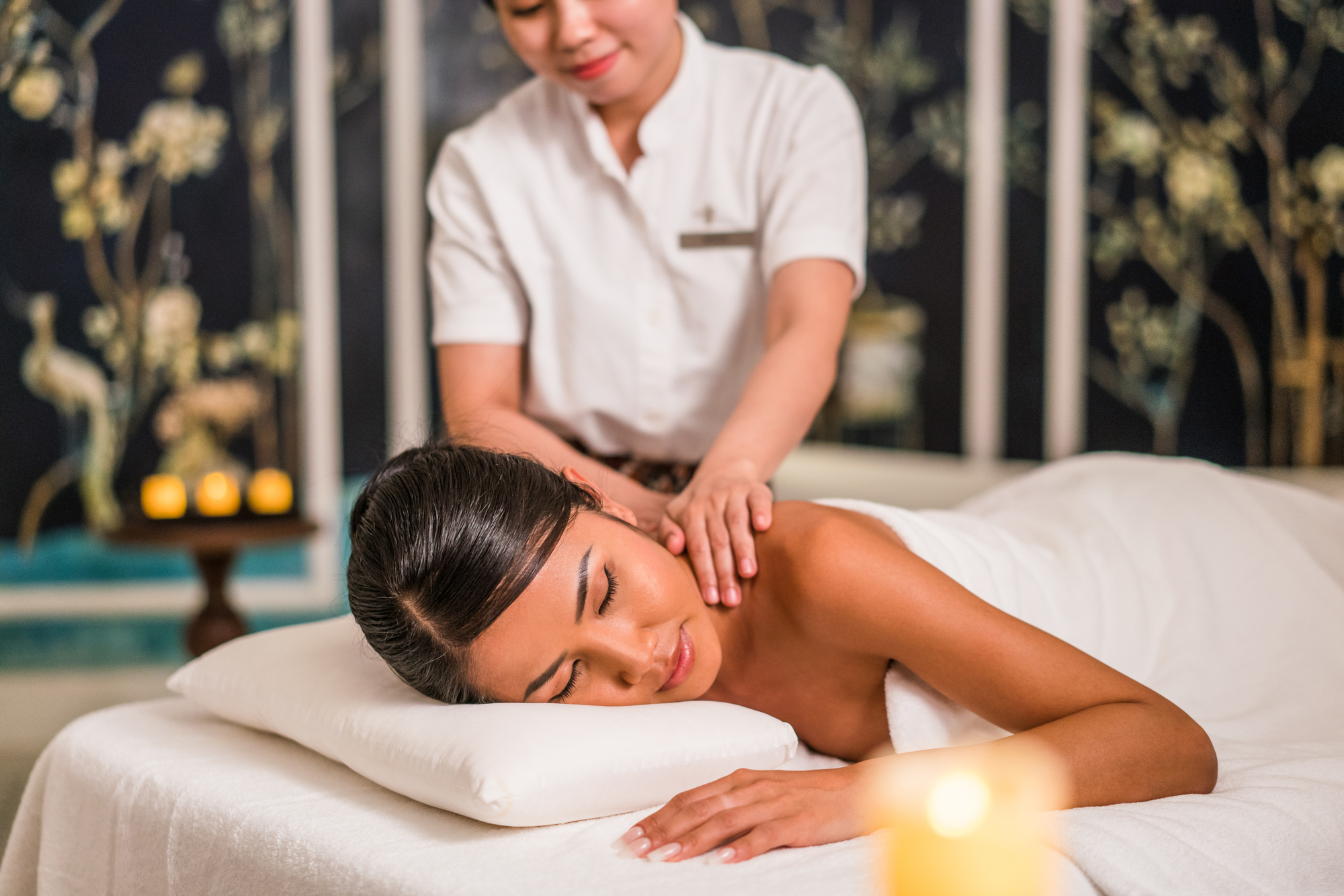 A woman gets a massage in a luxury hotel spa