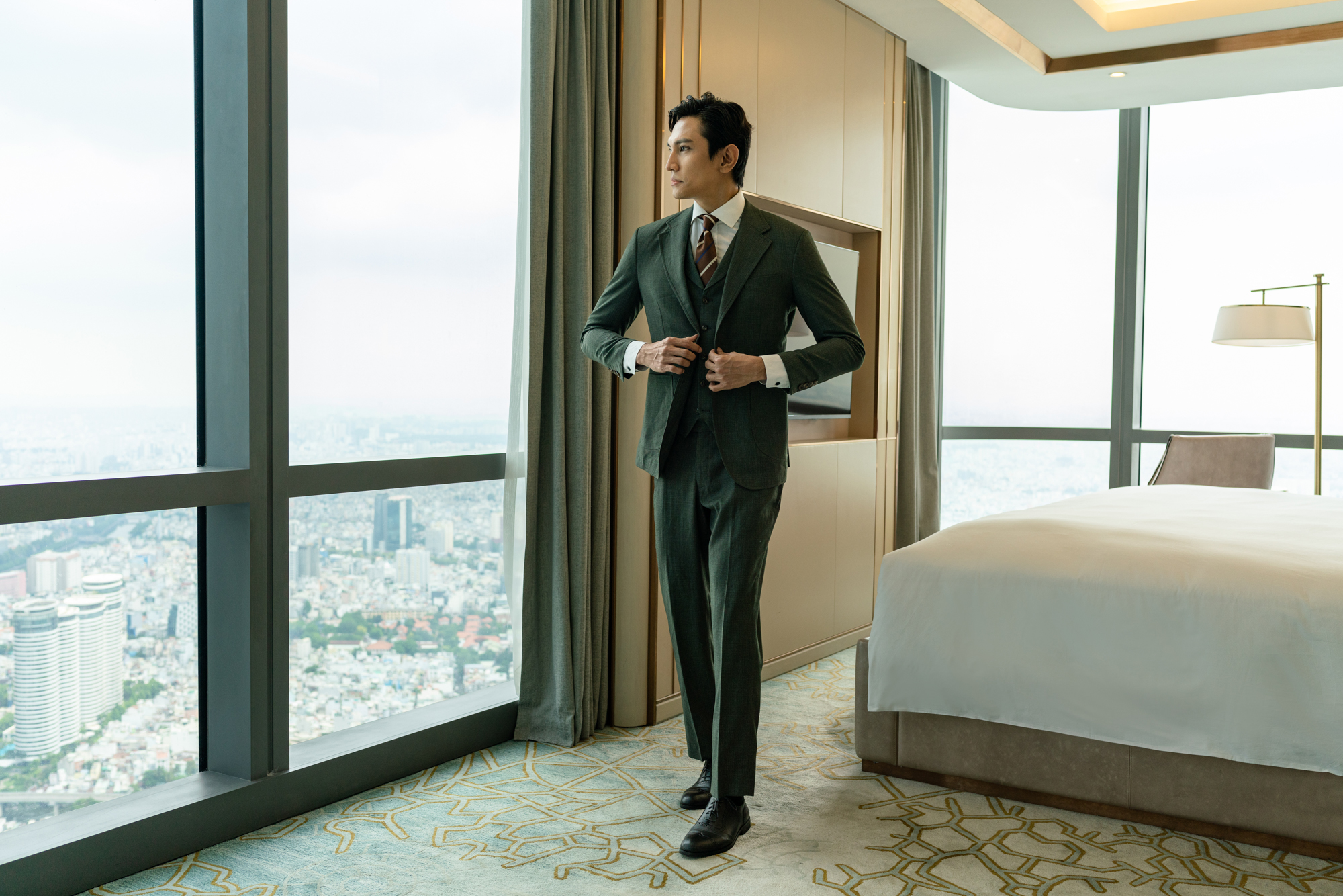 A businessman dresses in a five star high rise hotel