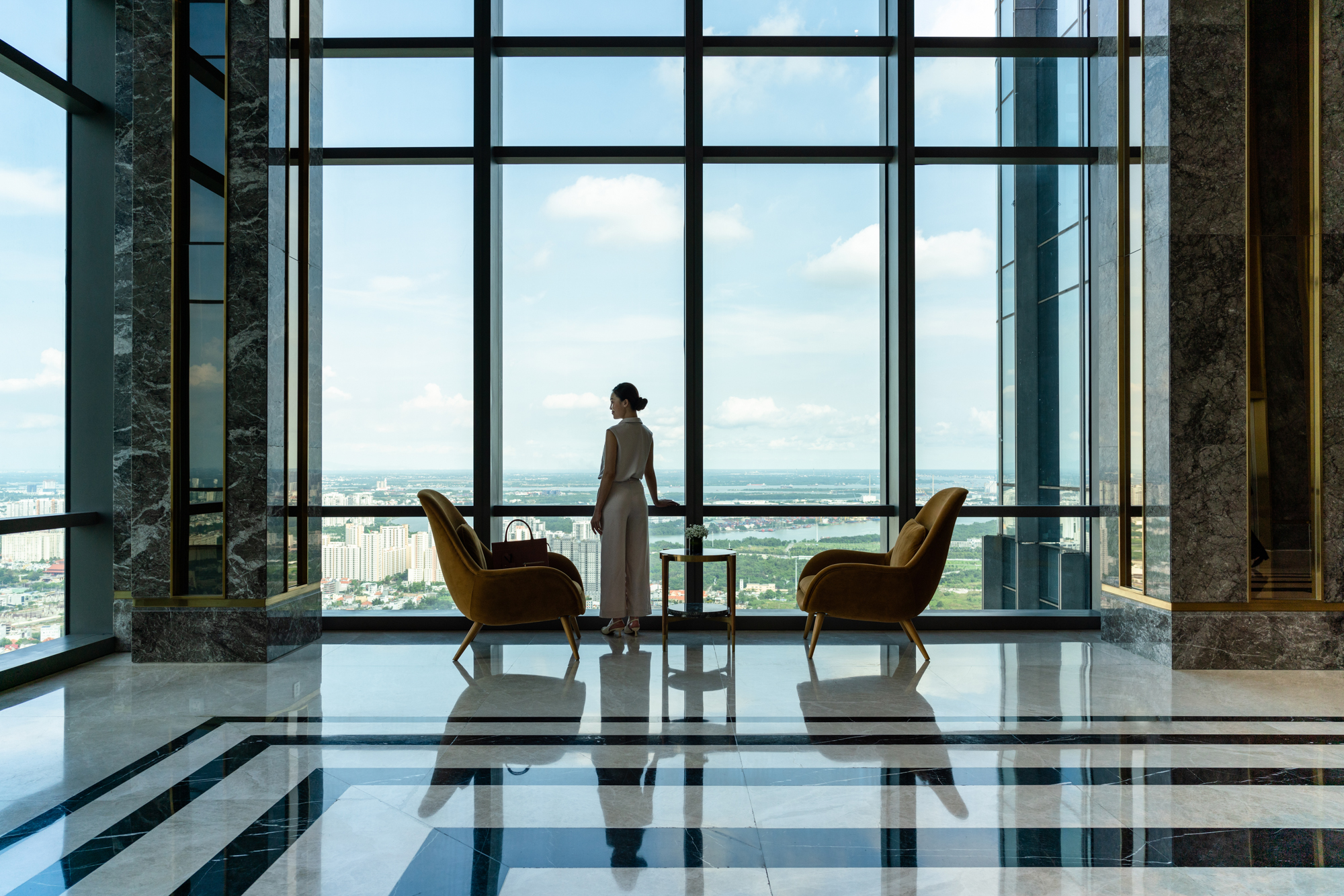 A woman takes in the views of Ho Chi Minh City from a high rise hotel