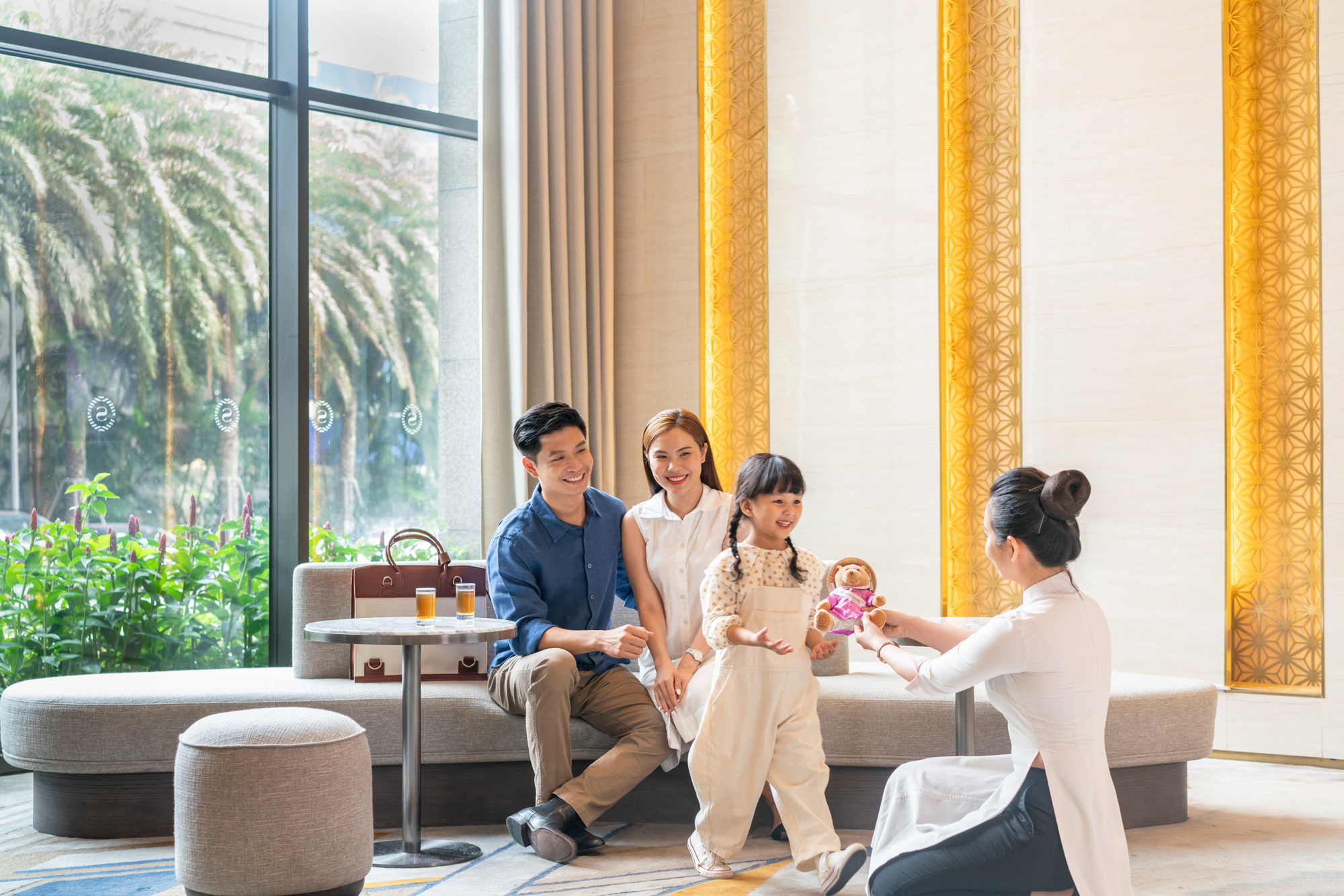 A family checks to a five star hotel, their child receives a gift from the hotel