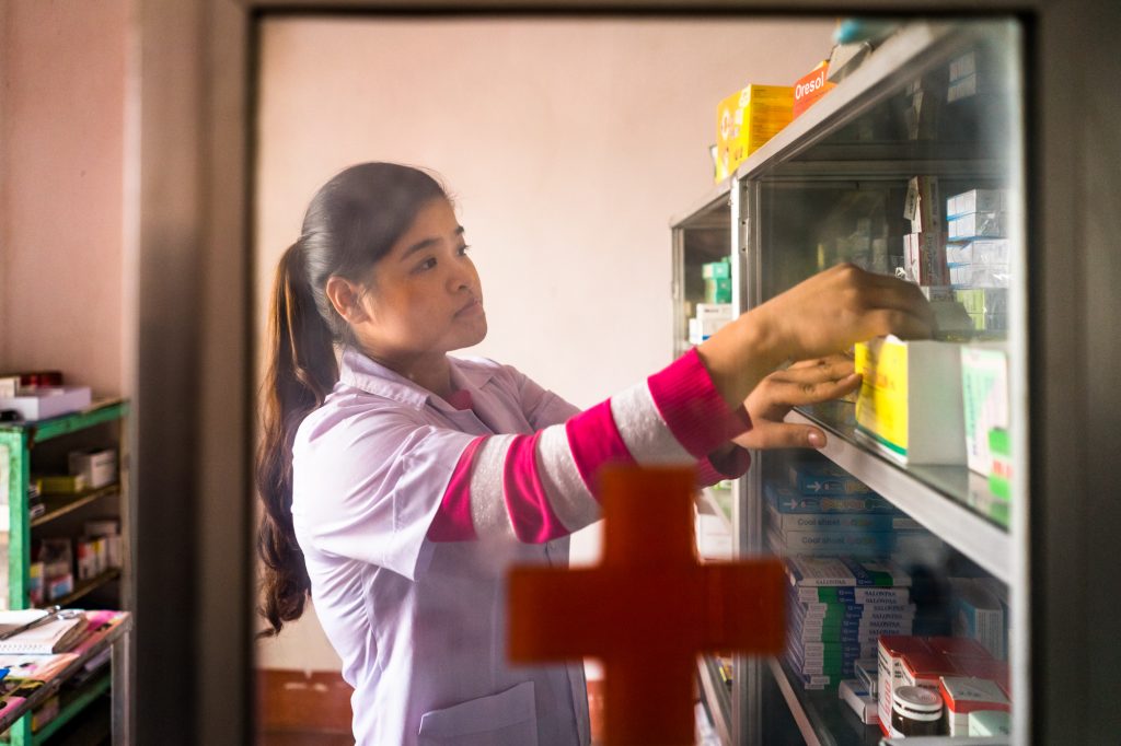 A nurse checks the medicine in a small pharmacy at a rural commune health center in Doi Son, Ha Nam Province, Vietnam.