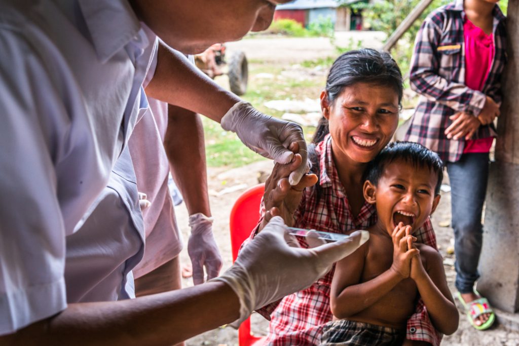A woman is screened for Malaria in her village in rural Cambodia