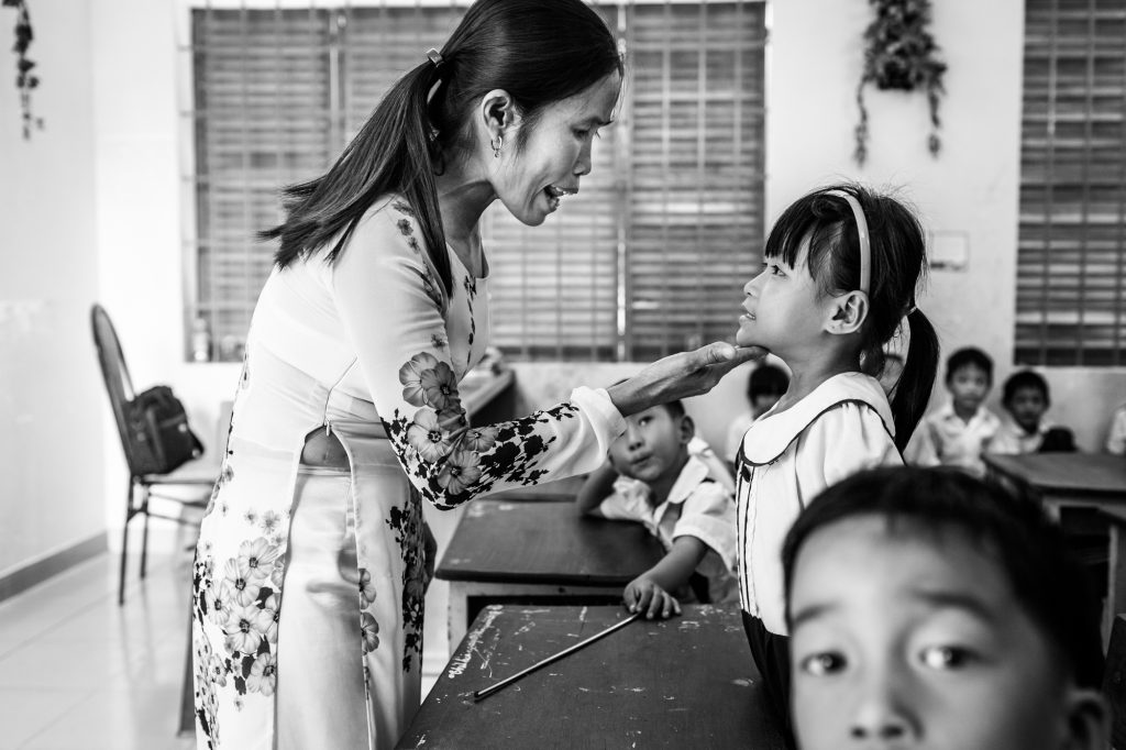 A teachers helps hearing impaired students with their pronunciation at a school in Ho Chi Minh City, Vietnam