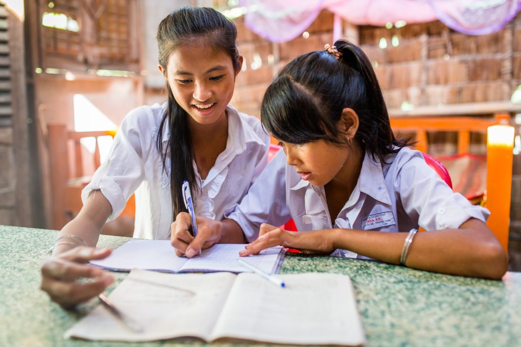 Two sisters study together at their home in the Mekong Delta region of Vietnam