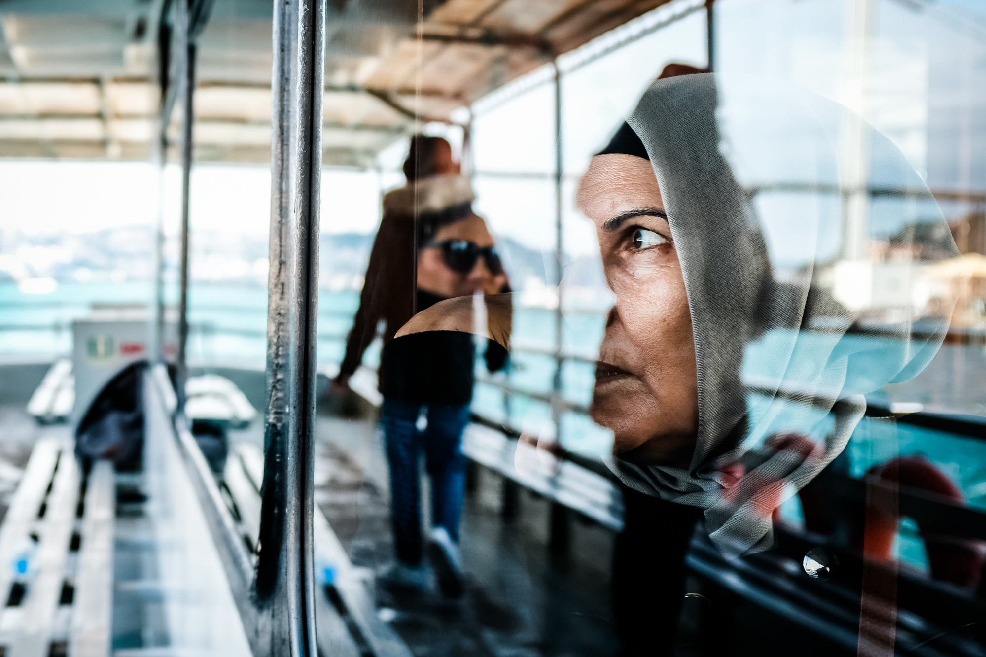 A Muslim woman looks out the window of a ferry boat in Istanbul, Turkey