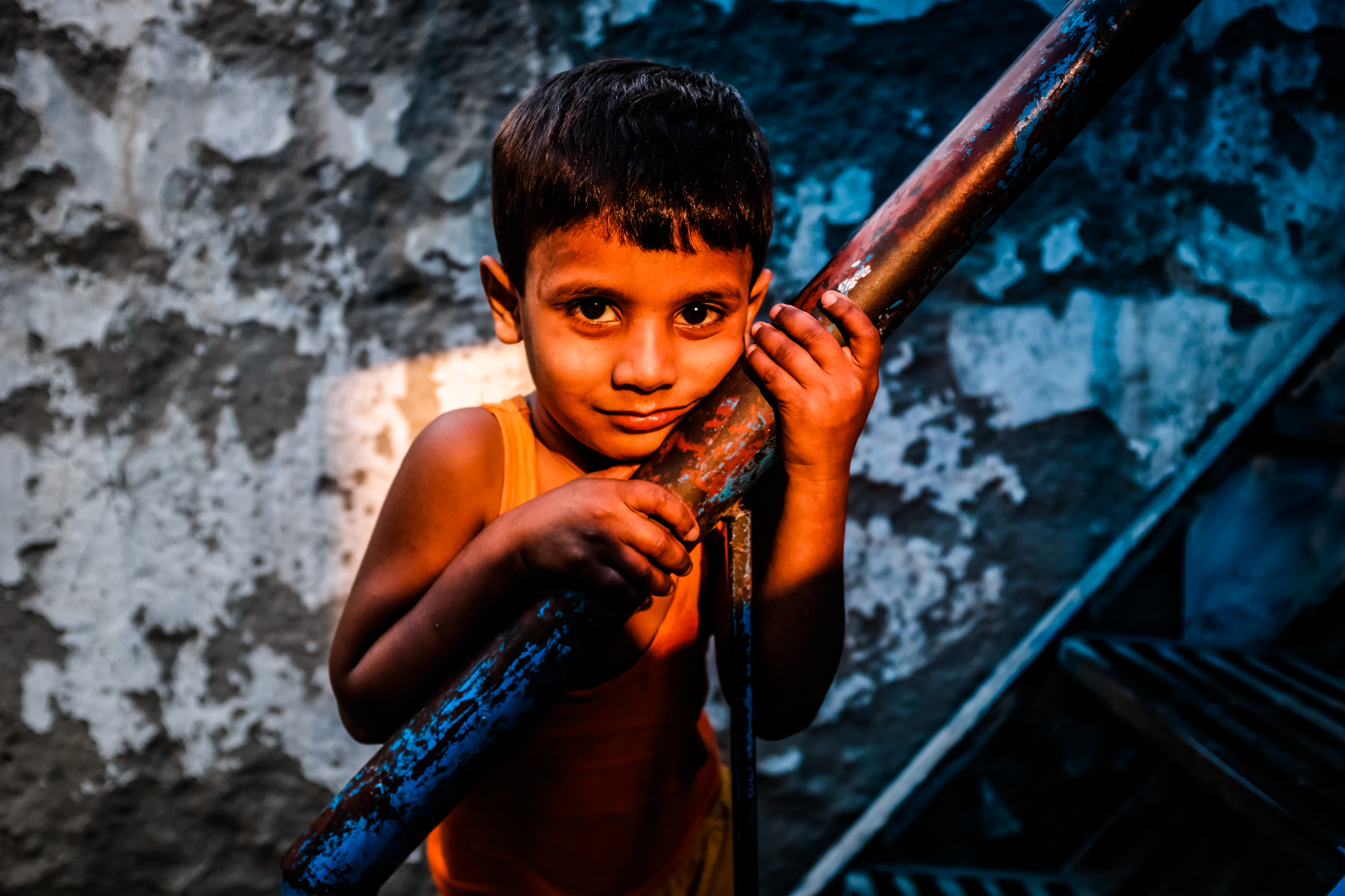 A portrait of an Indian boy in a back alley of Delhi, India at sunset